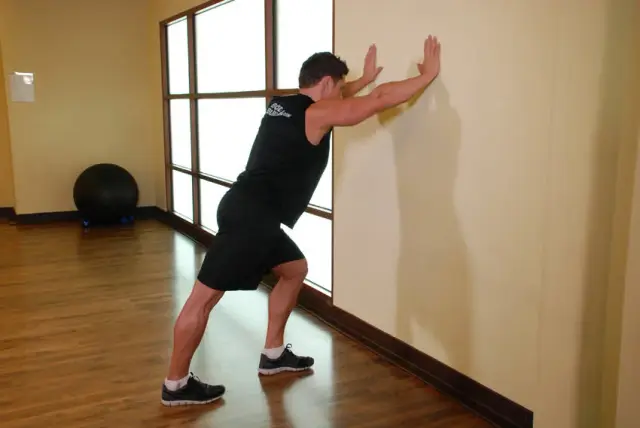 Calf Stretch Hands Against Wall — Start