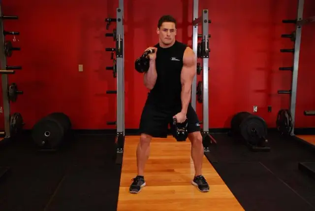 Double Kettlebell Alternating Hang Clean — End