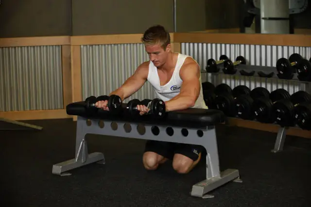 Palms-Down Dumbbell Wrist Curl Over A Bench 2