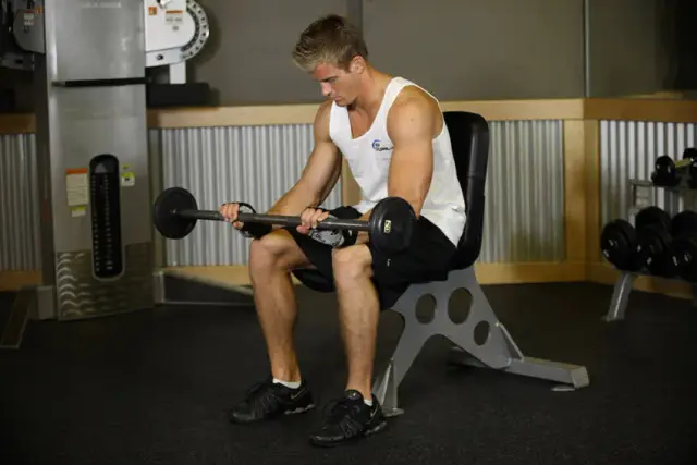 Seated Palms-Down Barbell Wrist Curl — End