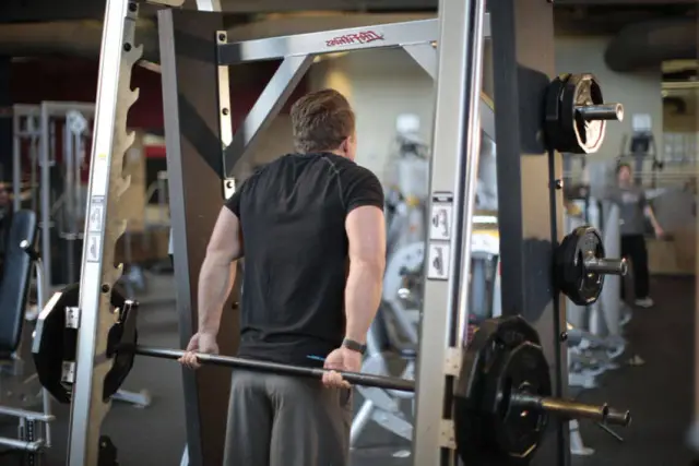 Smith Machine Behind the Back Shrug — End