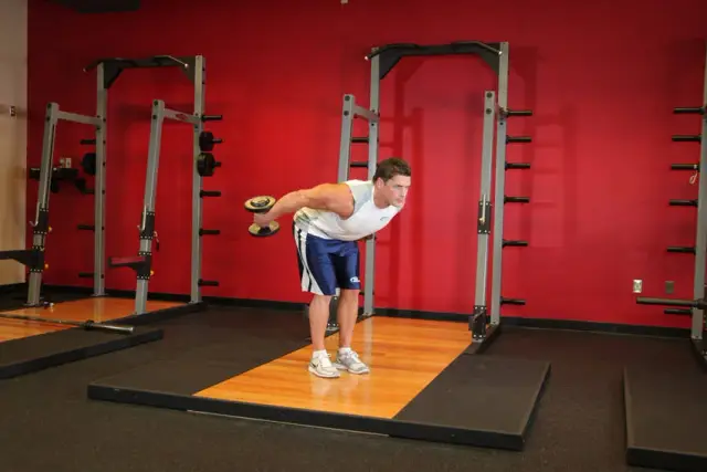 Standing Bent-Over Two-Arm Dumbbell Triceps Extension — End