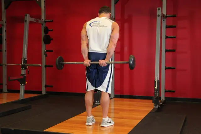 Standing Palms-Up Barbell Behind The Back Wrist Curl 1